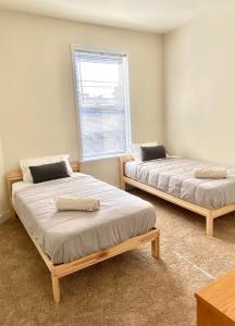 Dos camas en una habitación con ventana. en 118-1 GB Internet Great Summer 2 Bed 2 Bath Stay, en Hoboken