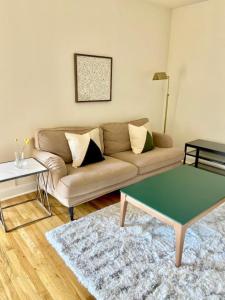 a living room with a couch and a coffee table at 124-2 Bedroom 2 Bath Apt in Heart of Hoboken in Hoboken