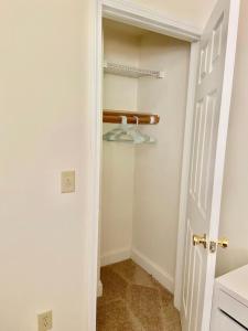 a bathroom with a closet with a white door at 124-2 Bedroom 2 Bath Apt in Heart of Hoboken in Hoboken