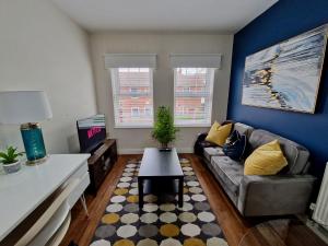 a living room with a couch and a table at Chic Luxury Serviced Apartment next to City Centre with Free Parking - Contractors & Relocators in Coventry