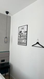 une photo sur un mur dans une pièce avec une lampe dans l'établissement Kamienica Łódzka, à Łódź