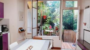 a room with a table and a large window at Grande maison en Aubrac in Chaudes-Aigues