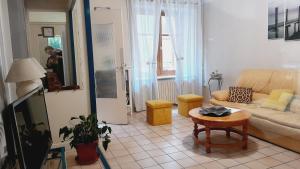a living room with a couch and a table at Grande maison en Aubrac in Chaudes-Aigues