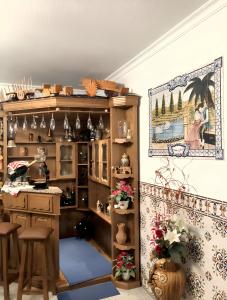 een kamer met een keuken met een aanrecht en een plank bij 4 bedrooms house with city view enclosed garden and wifi at Corticada in Cortiçada