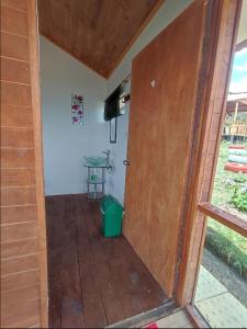 an open door to a porch with a table in a room at El Mirador de Juan in Guasca