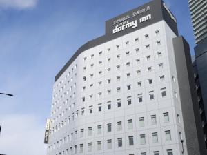a white building with a sign on it at Dormy Inn Gifu Ekimae in Gifu