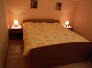 ein Schlafzimmer mit einem Bett mit zwei Nachttischen und zwei Lampen in der Unterkunft Apartment Mirjana in Prvić Luka