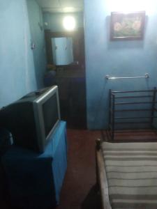 a tv sitting on a table in a room at REVESTON HOLIDAYS in Matale