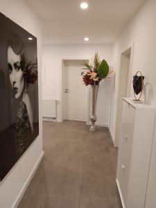 a hallway with a vase of flowers on a wall at Ferienwohnung Zimmermann in Bad Schandau