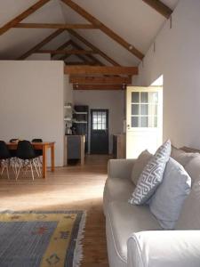 a living room with a couch and a table at Moira's Cottage in Calitzdorp
