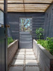 a door to a house with a walkway with at Moira's Cottage in Calitzdorp