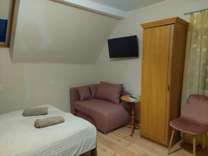 ein kleines Zimmer mit einem Bett und einem Stuhl in der Unterkunft Magnolia Gospodarstwo Agroturystyczne in Kazimierz Dolny