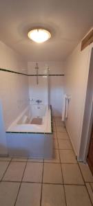 a white bathroom with a tub and a sink at Chambres d hotes near Mâcon with secure Parking in Grièges