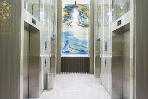 a hallway with elevators in a building with a painting at Royal Suites Studio 18ZY - Citra Plaza Nagoya in Jodoh