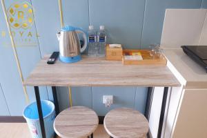 a table with two wooden stools on a counter at Royal Suites Studio 18ZY - Citra Plaza Nagoya in Jodoh +14 photos