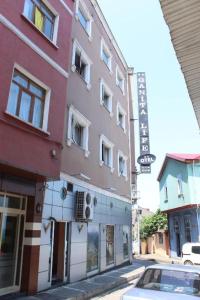 a car parked in front of a building on a street at Ganita Otel Trabzon in Trabzon