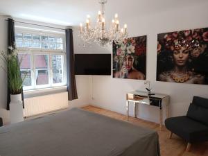 a living room with a bed and a chandelier at Ferienwohnung Zimmermann in Bad Schandau