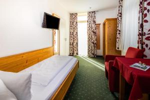 Postel nebo postele na pokoji v ubytování Hotel Gruenberger