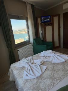 a hotel room with a bed with towels on it at Ganita Otel Trabzon in Trabzon