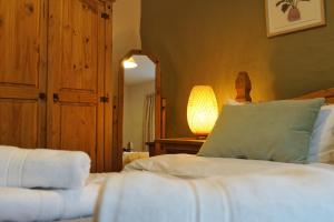 A bed or beds in a room at Kids Fun Farm Themed Bedroom in Cosy Cob Cottage