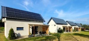 a house with solar panels on the roof at Domki Swornegacie - Sielsko Anielsko in Swornegacie 