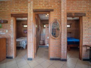 a brick wall with two doors and a mirror at 2 bedroom apartment with bay view, deck and roof terrace in San Juan del Sur