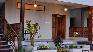 Zahrada ubytování Poojaris Nirantara - Mysuru