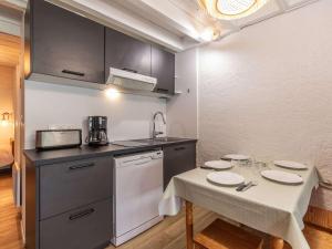 a small kitchen with a table and a counter top at Appartement Cauterets, 2 pièces, 5 personnes - FR-1-401-290 in Cauterets
