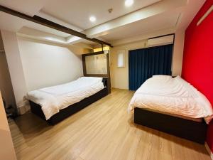 Giường trong phòng chung tại BOSS TAMAGAWA