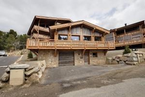 a large wooden house with a balcony on top at Chalet nid des écureuils in Font-Romeu-Odeillo-Via
