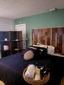 a bedroom with a blue bed with a wooden headboard at Life is good in St. Petersburg