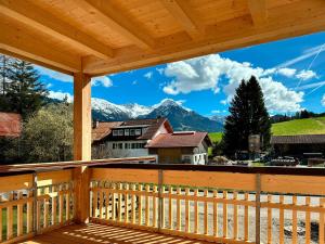 a view from the deck of a cabin with mountains at Chalet Allgäu in Fischen