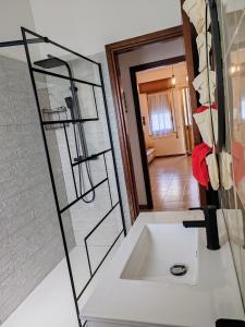a bathroom with a sink and a mirror at Trapani Emotions apartment in Valderice