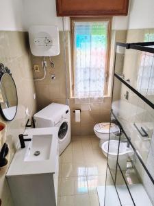 a small bathroom with a toilet and a sink at Trapani Emotions apartment in Valderice