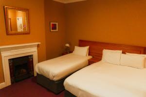 Postel nebo postele na pokoji v ubytování Phoenix Park Hotel