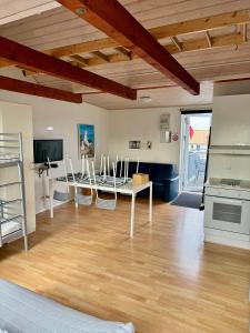 a living room with a table and chairs at Nørager Apartments in Nørager +10 photos