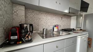 a kitchen with a sink and a counter top with a counter at Thalassa Kai almira studios in Sarti +29 photos
