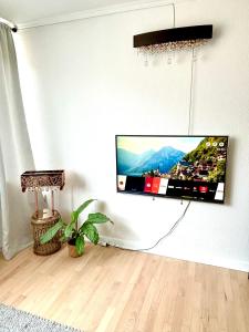 a flat screen tv hanging on a wall at Luxurious Boutique Apartment, inner city, next to Canals and Metro station in Copenhagen