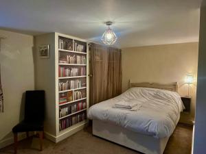 a bedroom with a bed and a book shelf with books at Parkside in Pateley Bridge