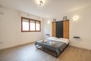 a bedroom with a large bed in a room at Cavour Home in Porto Torres