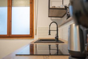 a kitchen with a sink and aaucet at Cavour Home in Porto Torres +21 photos