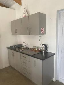 a kitchen with a sink and a counter top at Sunset View Self- Catering Yzerfontein in Yzerfontein