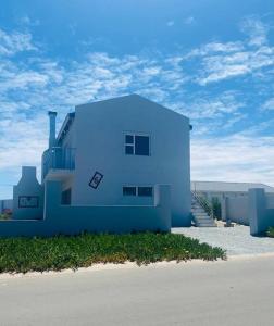 a blue building on the side of a road at Sunset View Self- Catering Yzerfontein in Yzerfontein