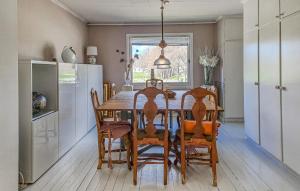 a kitchen with a dining room table and chairs at Cozy Apartment In Tjrn With Kitchen 