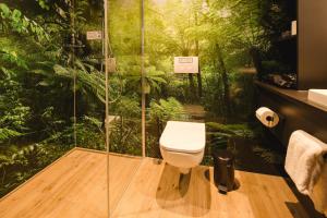 a bathroom with a shower with a toilet in the forest at Rioca Konstanz Posto 10 in Konstanz