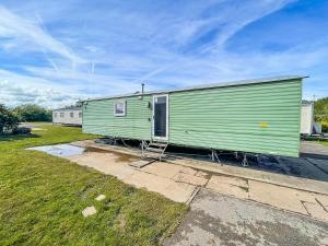 a large green building with a house at Lovely 8 Berth Caravan At Southview Park Nearby Skegness Ref 33009v in Skegness