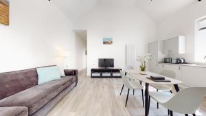 uma sala de estar com um sofá e uma mesa em Spacious three bedroom apartment with Valley views em Abertillery