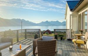 a patio with a view of the water at Cozy Home In Stokmarknes With House A Mountain View in Stokmarknes