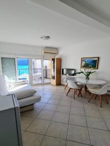 a living room with a couch and a table at Apartments Sun House in Herceg-Novi