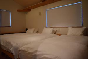 Кровать или кровати в номере コテージ nakara